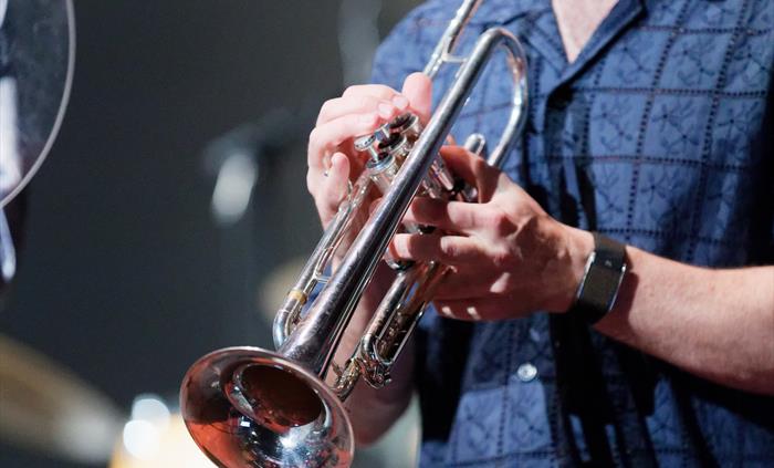 Close up of a man holiding a trumpet at the Swansea Jazz Festival